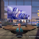Five avatars sit in a virtual conference room looking at a screen in a Microsoft Teams meeting.